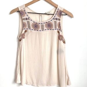 About a girl sleeveless cream top, Size M